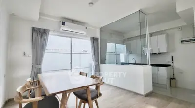 Modern open-layout kitchen and dining area with sleek design and natural light.