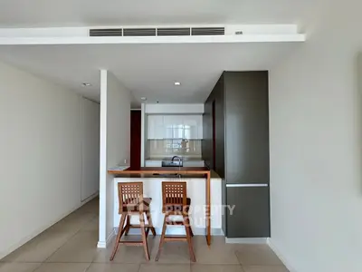 Modern kitchen with sleek design and breakfast bar in a contemporary apartment.