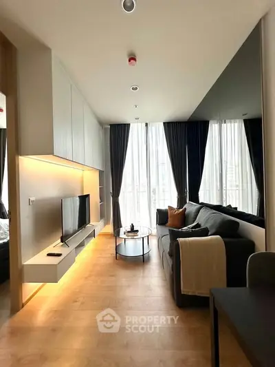 Modern living room with sleek design, large windows, and stylish furniture in a contemporary apartment.