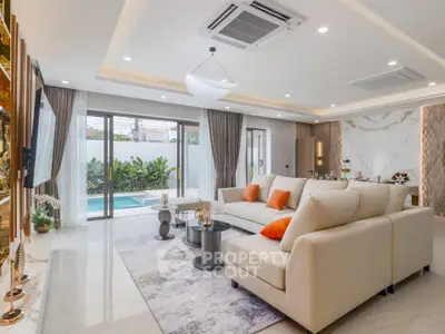 Luxurious living room with pool view and modern decor
