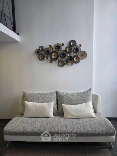Modern living room with stylish wall art and cozy sofa in a contemporary apartment.