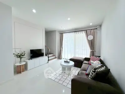 Modern living room with sleek furniture and natural light, perfect for relaxation and entertainment.