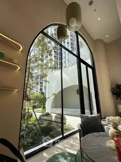 Luxurious modern apartment with large arched window offering stunning garden view, elegant interior design.