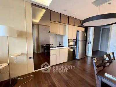 Modern kitchen with sleek appliances and open layout in stylish apartment.