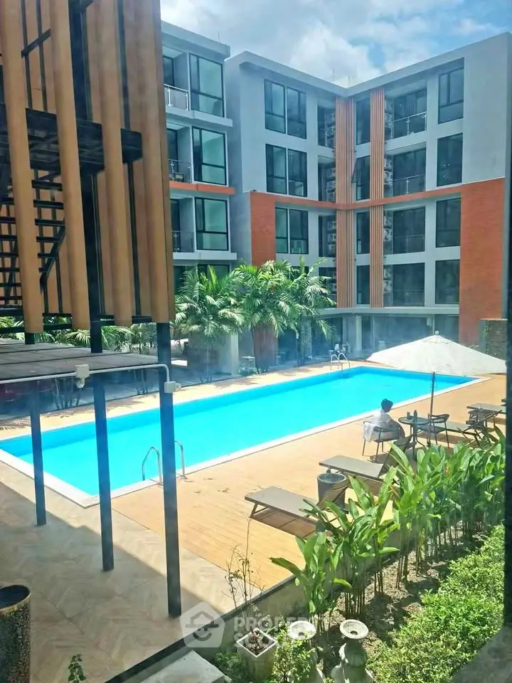Modern apartment complex with inviting outdoor pool and lush greenery
