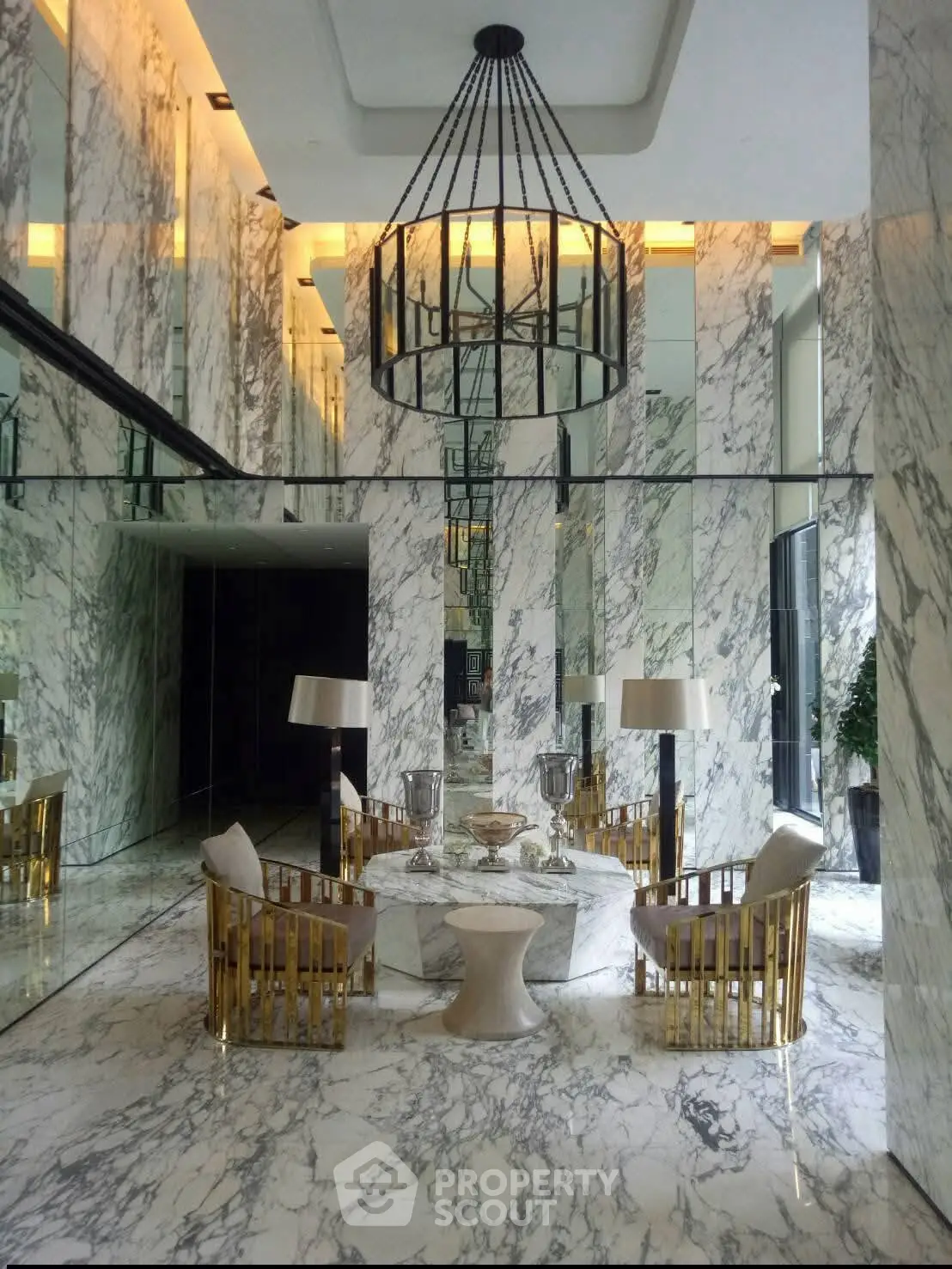 Luxurious marble lobby with elegant seating and chandelier in modern building