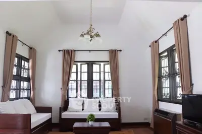 Charming living room with high ceiling and elegant decor