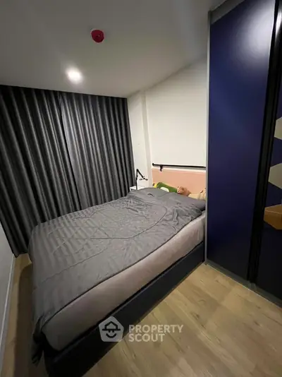 Cozy modern bedroom with stylish decor and ample natural light
