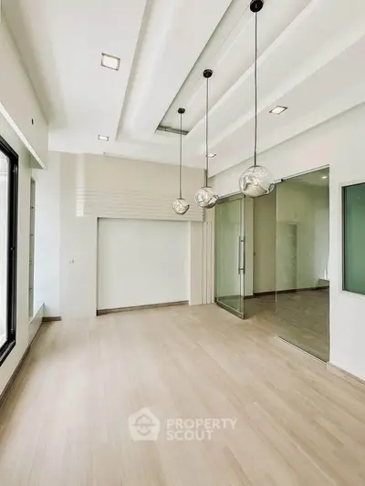 Spacious modern living room with elegant lighting and large windows