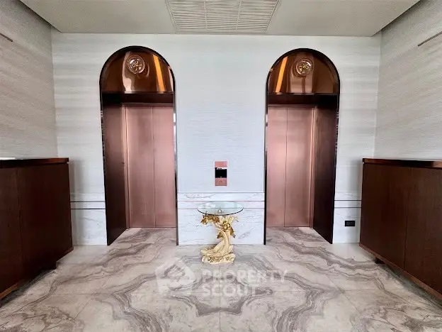 Luxurious elevator lobby with marble flooring and elegant decor