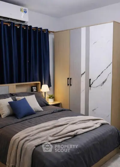 Cozy bedroom with modern wardrobe and elegant decor, perfect for relaxation and comfort.