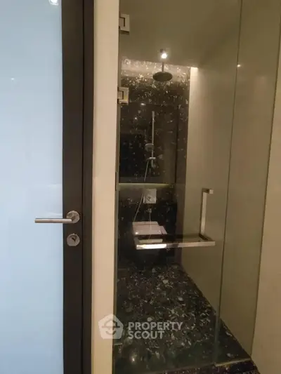 Modern bathroom with sleek glass shower enclosure and stylish fixtures