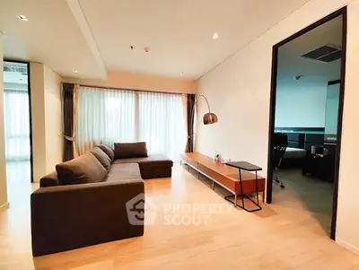 Spacious modern living room with large windows and stylish furniture