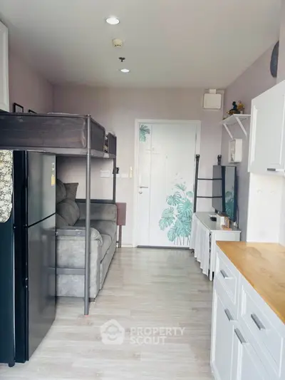 Modern compact living space with loft bed and stylish decor