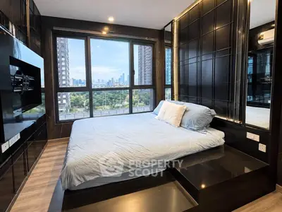Luxurious bedroom with stunning city view and modern design in high-rise apartment.