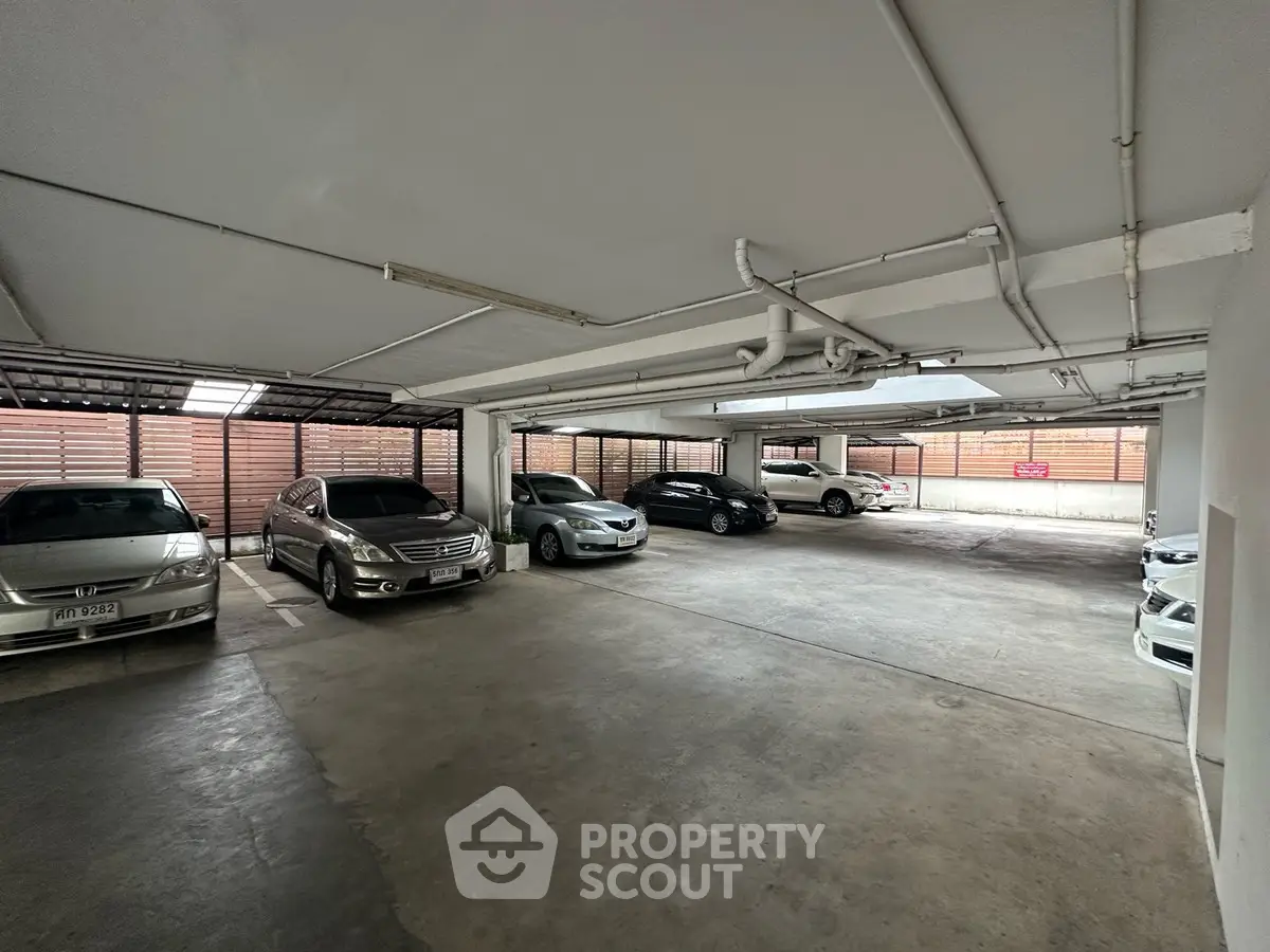 Spacious indoor parking area with multiple cars in a well-lit garage.