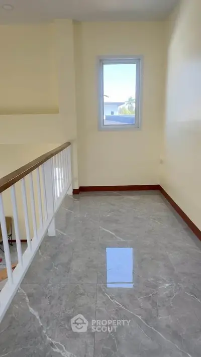 Bright hallway with marble flooring and a window view