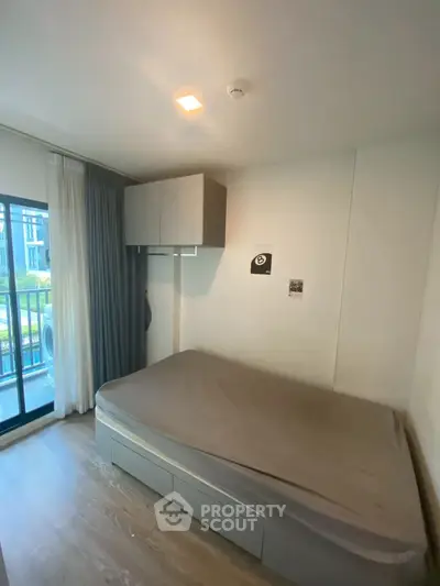 Cozy bedroom with balcony access in modern apartment