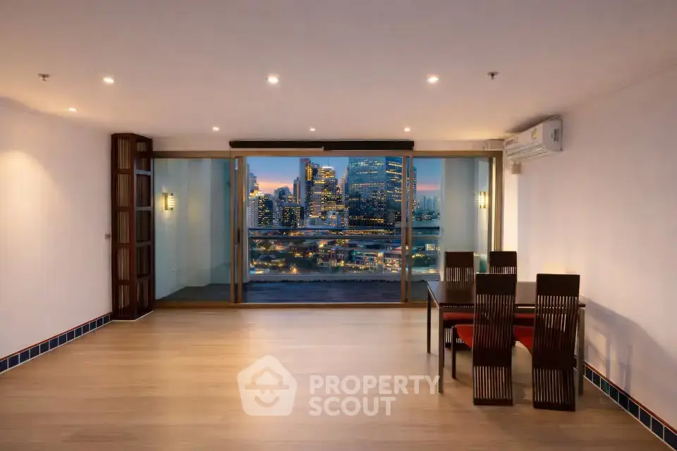 Spacious living room with city skyline view and elegant dining area