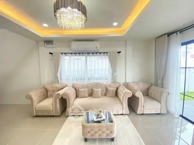 Elegant living room with plush sofas and modern chandelier