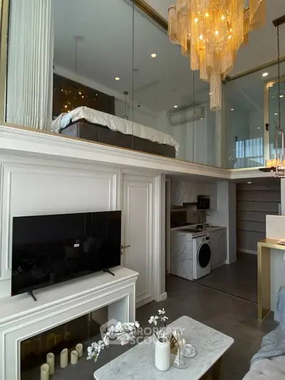 Luxurious loft apartment with modern interior, featuring a mezzanine bedroom, stylish chandelier, and sleek kitchen.