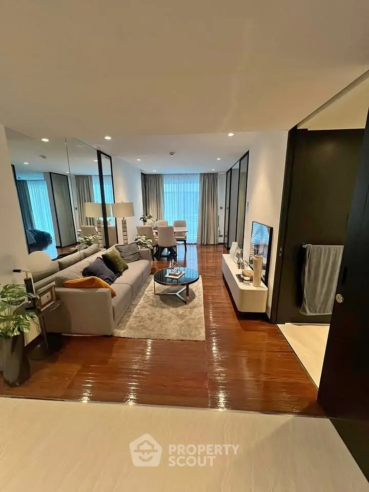 Modern living room with stylish decor and cozy ambiance, featuring a plush sofa and elegant coffee table.