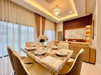 Luxurious open-plan living and dining area with elegant decor and ambient lighting.