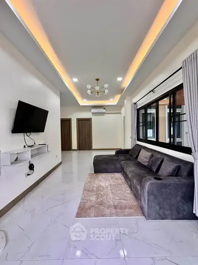 Spacious modern living room with sleek design and large windows for natural light.