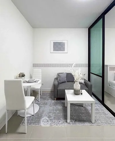 Modern living room with sleek furniture and glass partition, perfect for urban living.