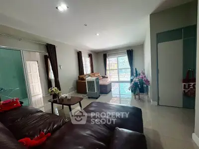 Spacious living room with modern furniture and large windows for natural light.