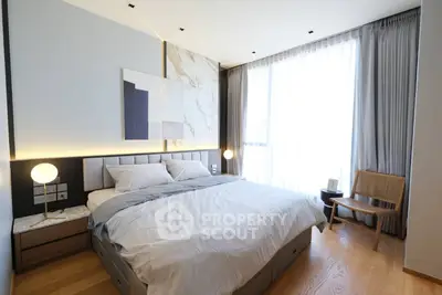 Modern bedroom with elegant decor, large window, and stylish furniture in a luxury apartment.