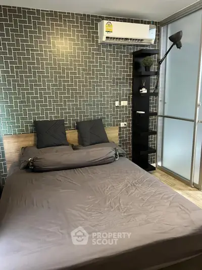 Modern bedroom with stylish geometric wallpaper and sleek air conditioning unit.
