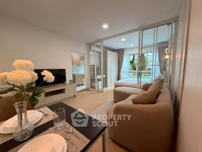 Modern open-plan living room with cozy sofa and elegant dining area