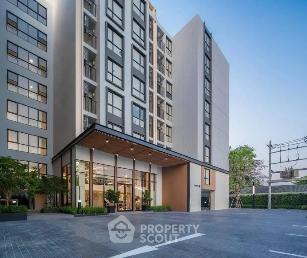 Modern apartment building with sleek design and spacious entrance