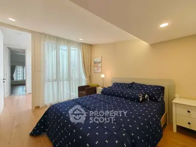 Spacious bedroom with modern decor and natural light