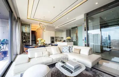 Luxurious modern living room with open kitchen and city view, featuring elegant decor and spacious layout.