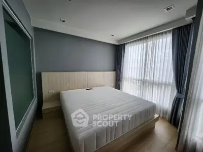 Spacious bedroom with large windows and modern decor