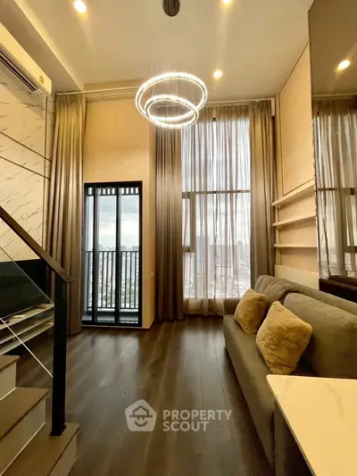 Luxurious high-ceiling living room with modern chandelier and city view balcony.