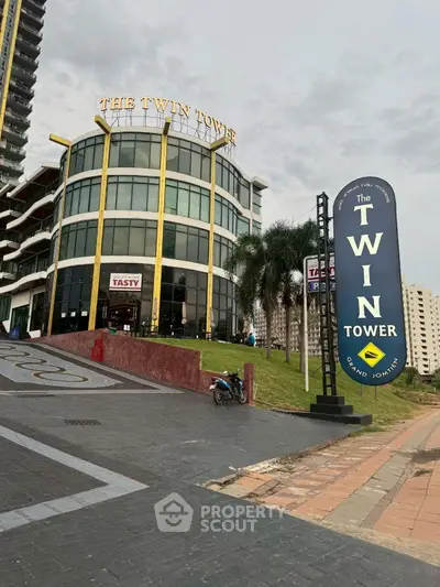 Modern commercial building with unique architecture and prominent signage in urban setting.