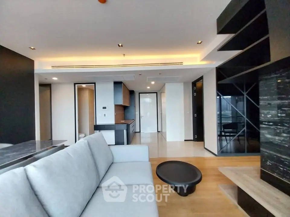 Modern living room with sleek design and open kitchen layout