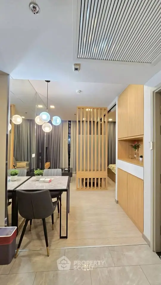 Modern open-plan living area with stylish dining set and wooden partition, perfect for contemporary urban living.