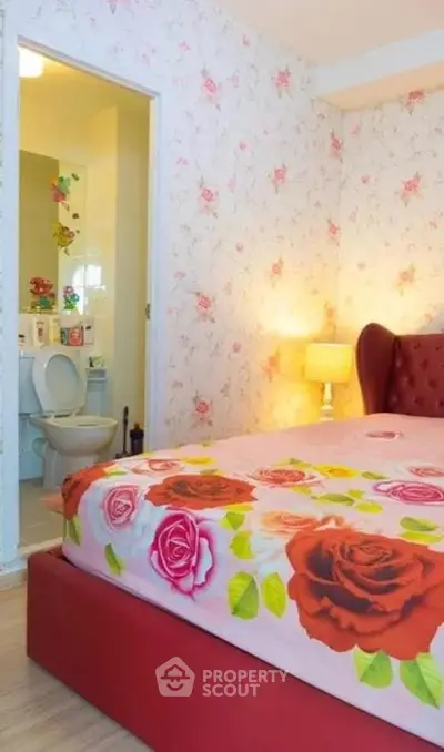 Charming bedroom with floral decor and ensuite bathroom, perfect for cozy living.