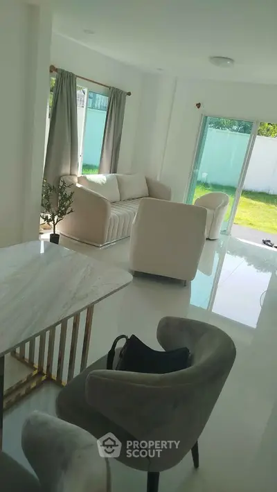 Bright modern living room with elegant furniture and garden view