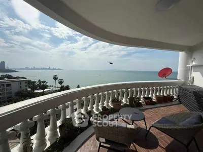 Stunning balcony with panoramic ocean view and cozy seating area, perfect for relaxation.