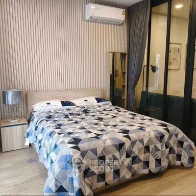 Modern bedroom with stylish decor and air conditioning in a contemporary apartment.