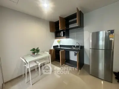 Modern kitchen with open cabinets and dining area in sleek apartment
