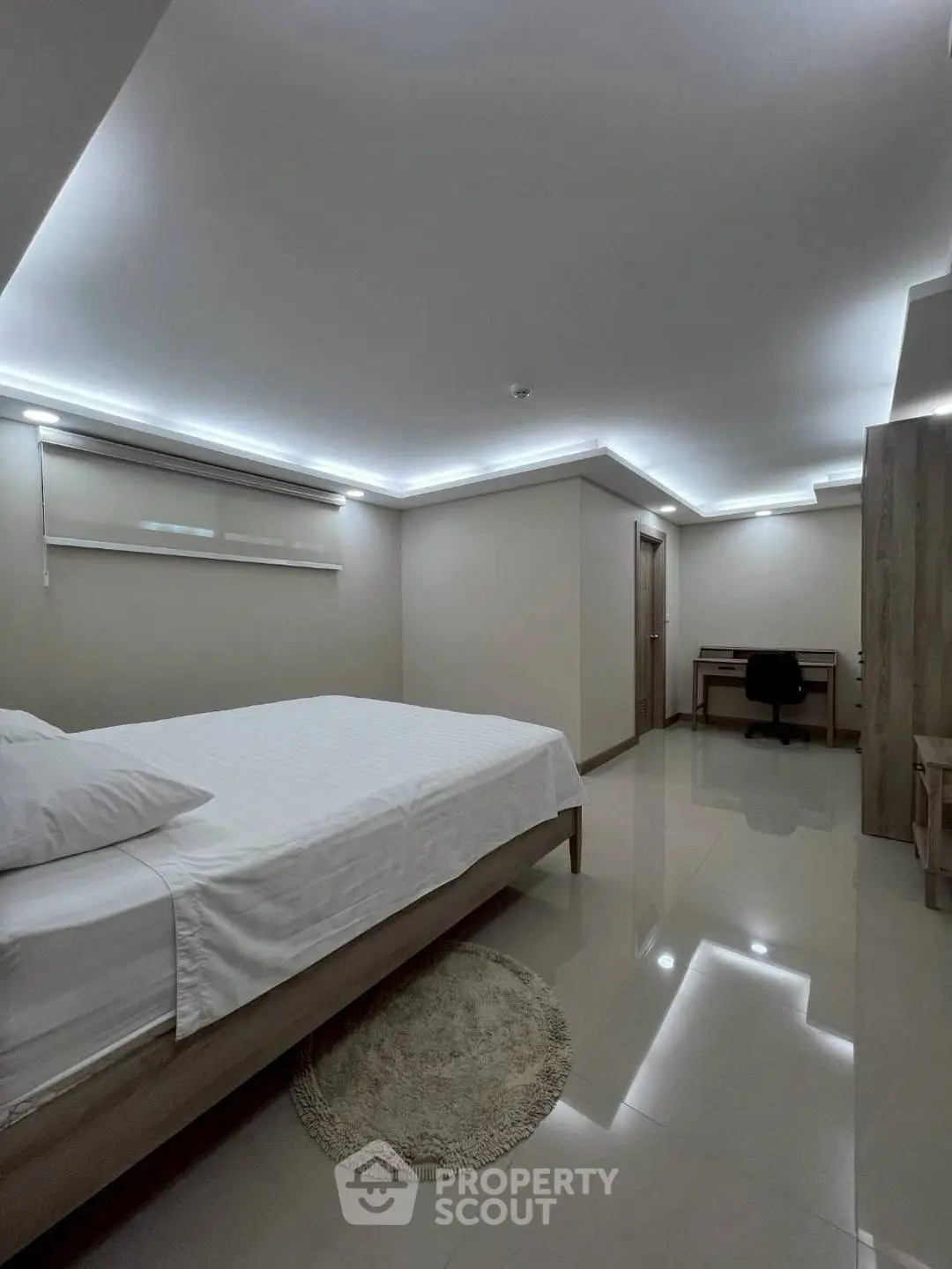 Modern minimalist bedroom with sleek design and ambient lighting