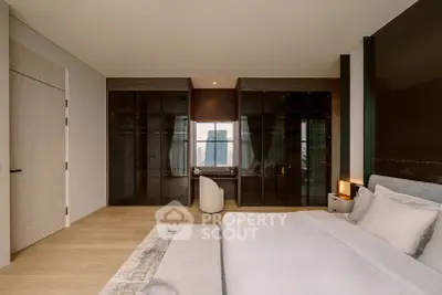Luxurious bedroom with modern design and city view, featuring elegant furnishings and ample storage space.