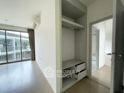 Spacious bedroom with built-in wardrobe and access to a private balcony, featuring ample natural light and modern flooring, ideal for personal customization.