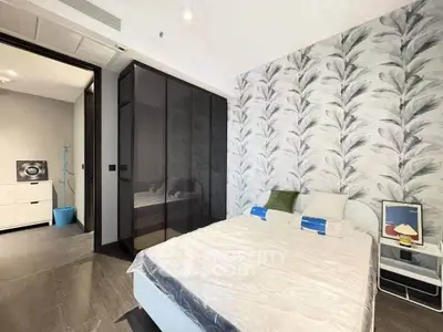 Modern bedroom with stylish wallpaper and sleek wardrobe design